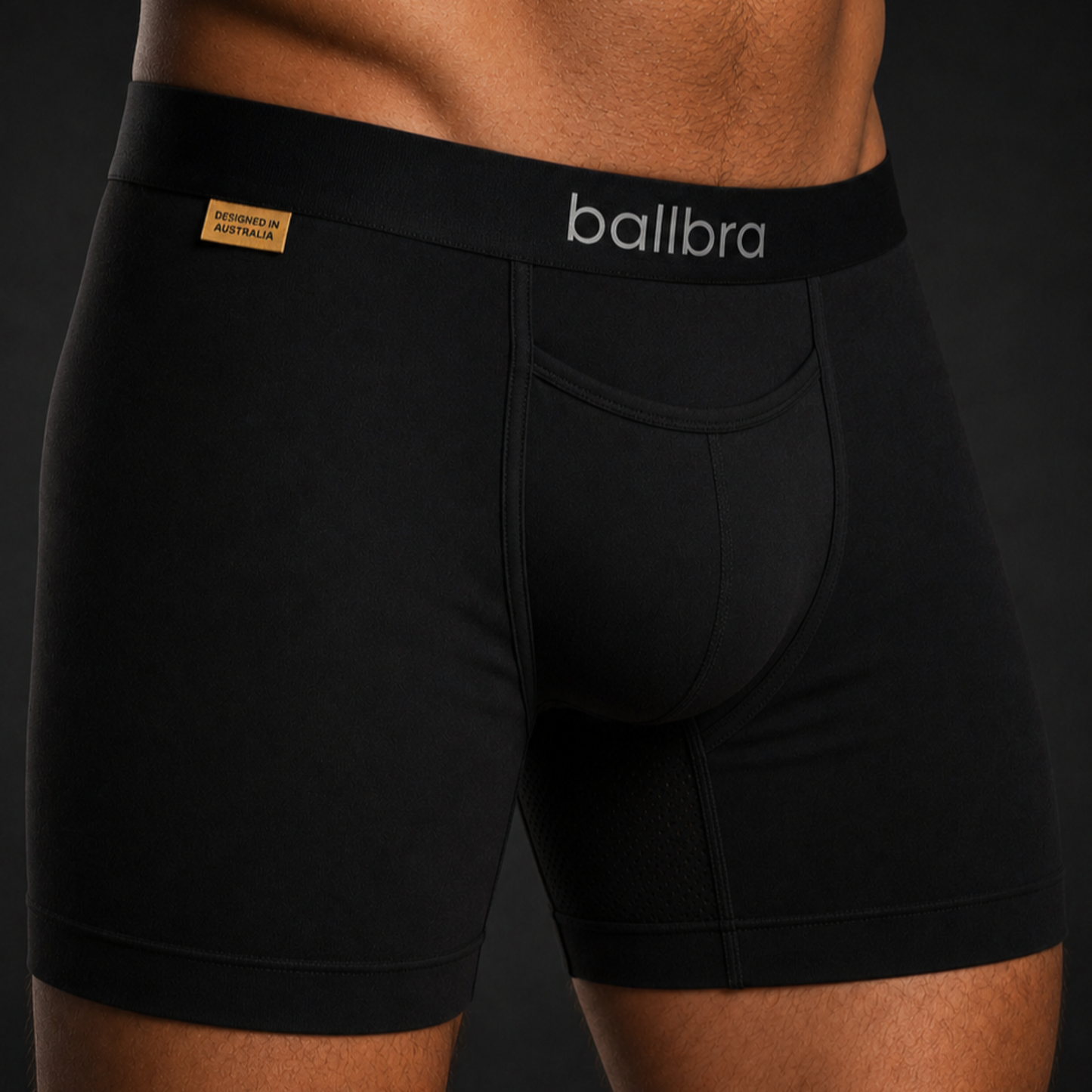 Close-up of black Ballbra boxer briefs on a model, showing the support pouch fit and modal fabric texture
